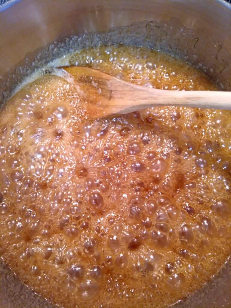 cooking the caramel sauce in a pot.