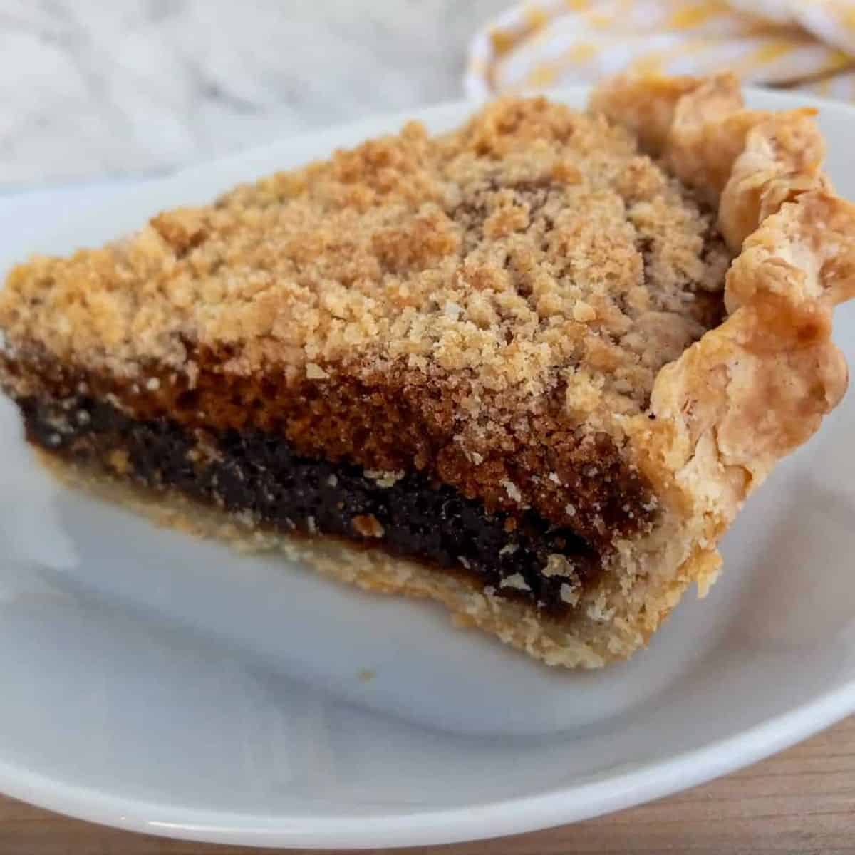 a slice of Amish shoofly pie giving you a close-up look at the three distinct layers.