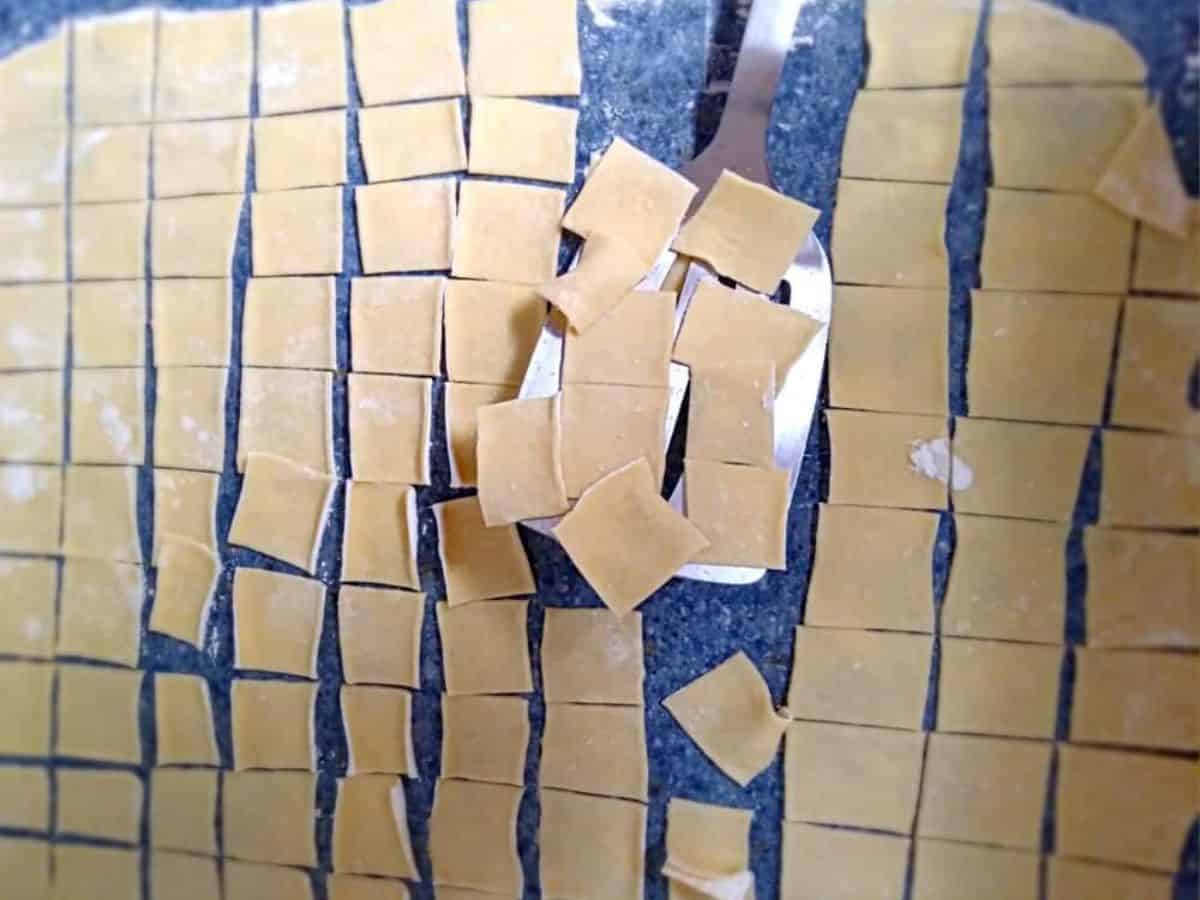 cutting homemade pot pie noodles.