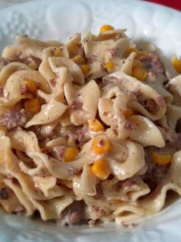 a bowl full of creamy Amish beef, noodle, and corn casserole