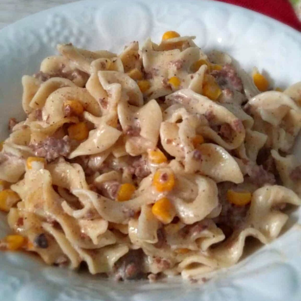 a bowl full of creamy Amish beef, noodle, and corn casserole