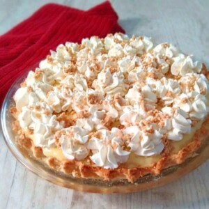 a 9" Amish peanut butter pie topped with whipped cream and peanut butter crumbles.
