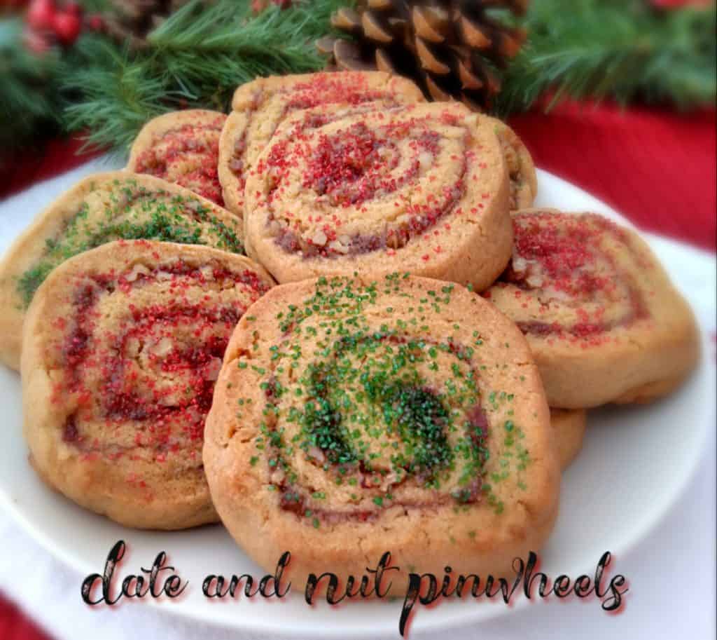 a plate full of date paste pinwheel cookies with Christmas sprinkles on top. 