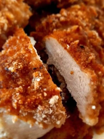 a platter with rice krispie chicken and one slice cut in half to give you an inside view.