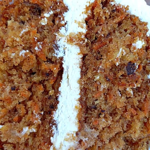 carrot cake with pineapple and pecans topped with cream cheese frosting