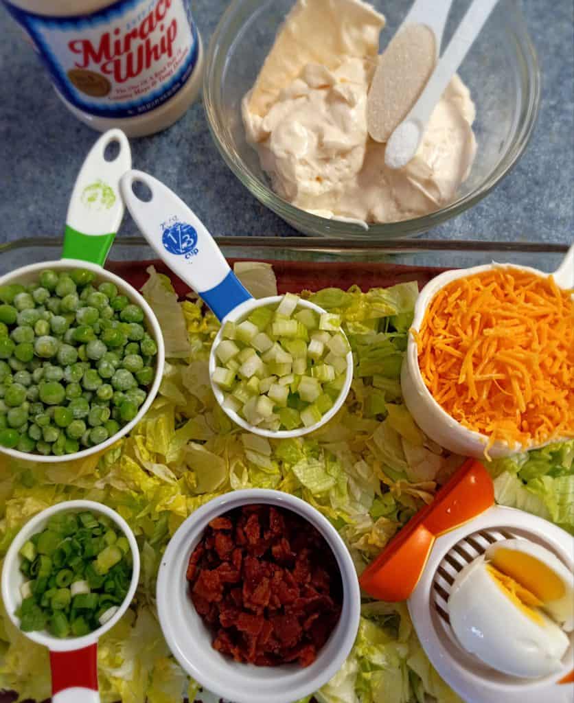 lettuce, dressing, and all the ingredients for layered salad