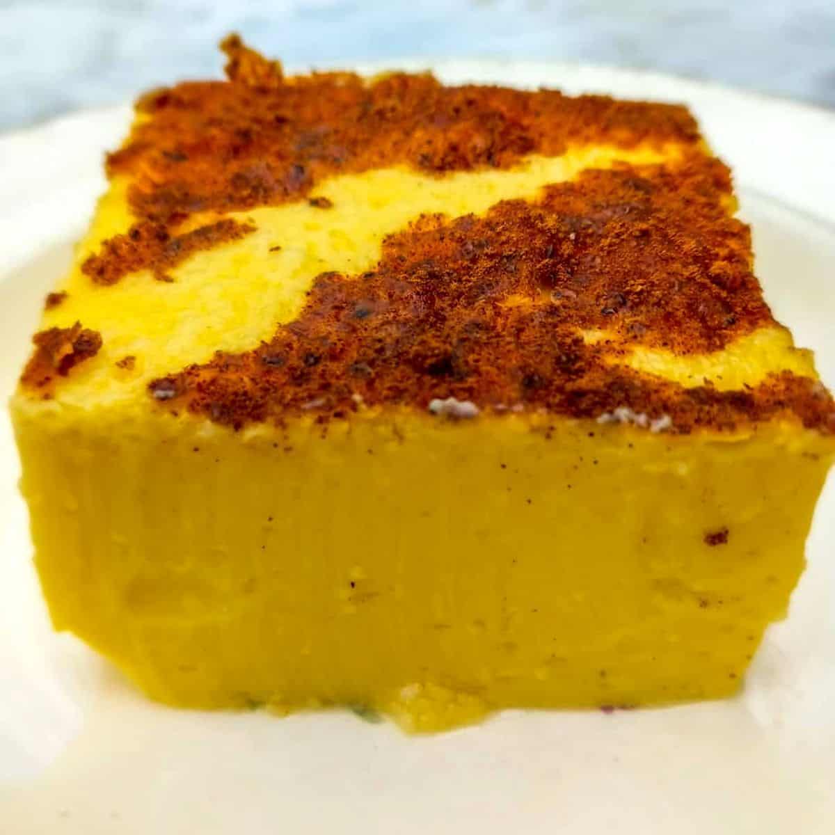 close up of a slice of egg custard on a plate.