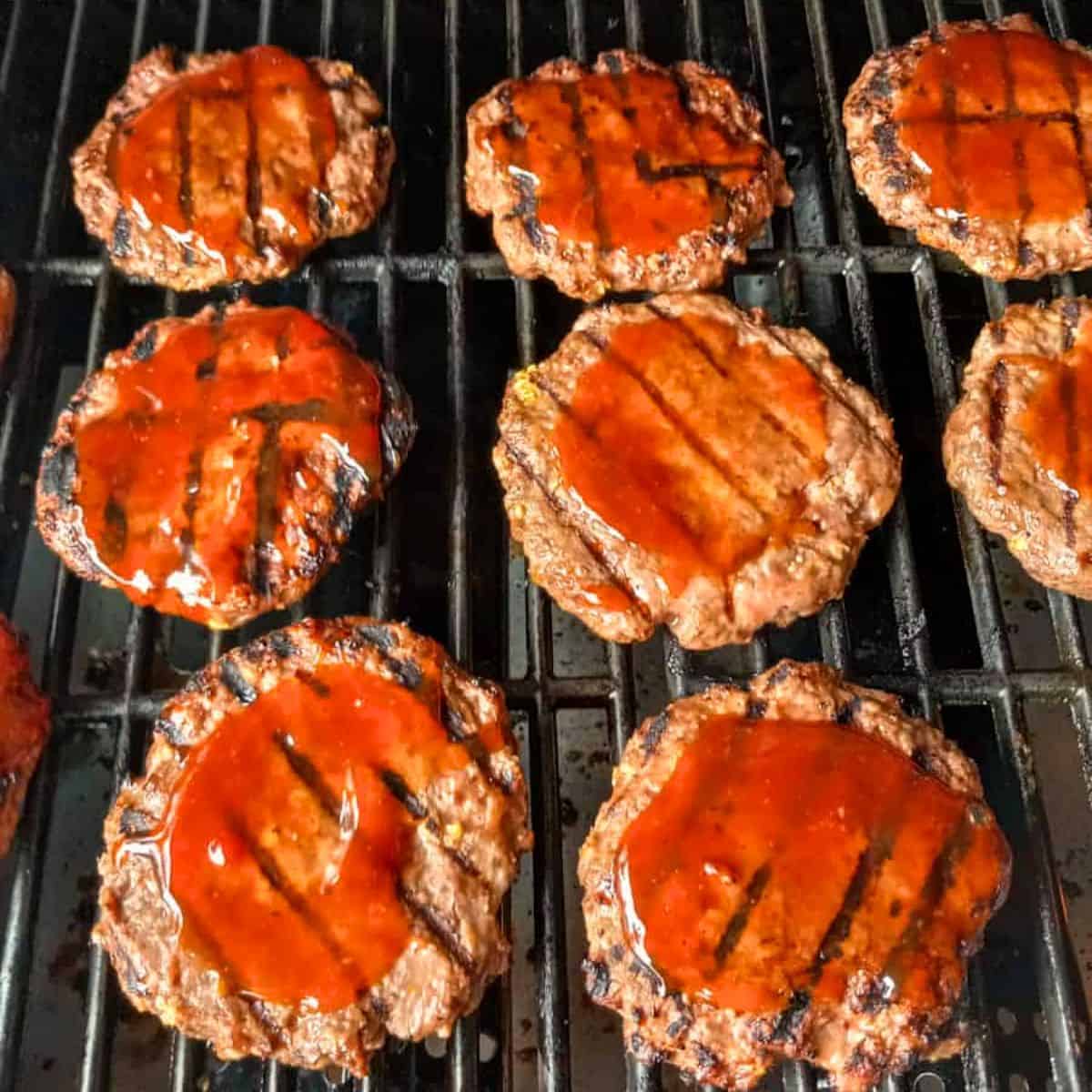 Moist Amish hamburgers with homemade BBQ sauce on the grill.