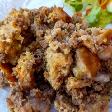 Amish hamburger stuffing on a plate with salad.