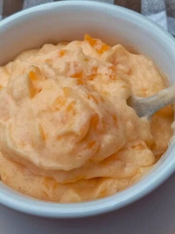 a small crock full of Amish yum yum orange jello salad.
