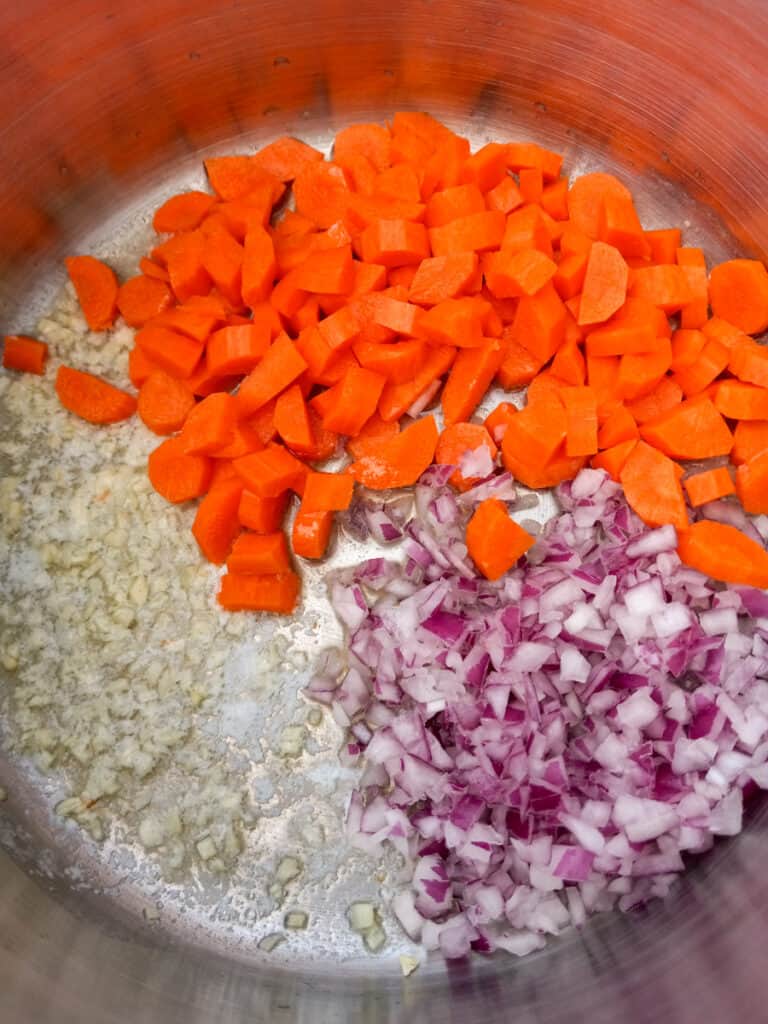 carrots, onions, and garlic in a pot