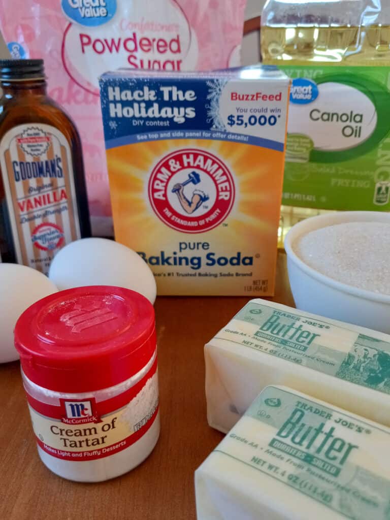 ingredients - powdered sugar, oil, butter, sugar, eggs, vanilla, baking soda, and cream of tartar
