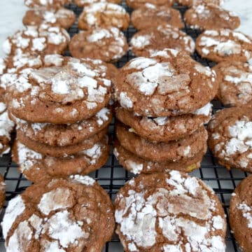 Amish mint chocolate cookies stacked on wire rack