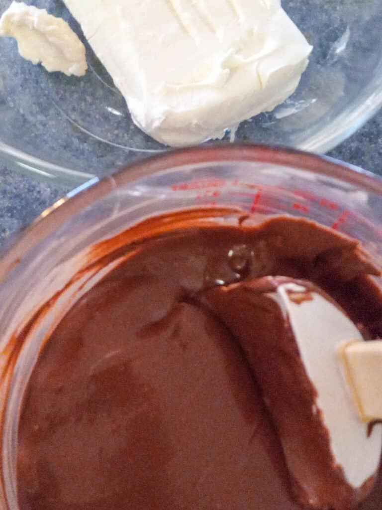bowl of melted chocolate and a bowl with cream cheese