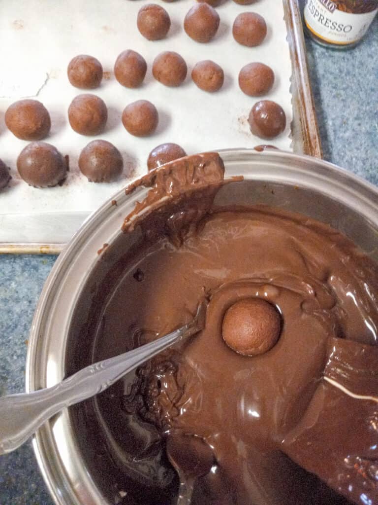 dipping truffle balls into chocolate
