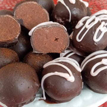 decorated and halved chocolate truffles on plate