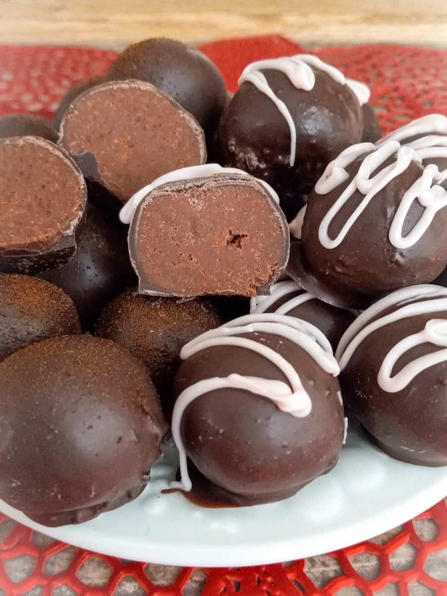 decorated and halved chocolate truffles on plate