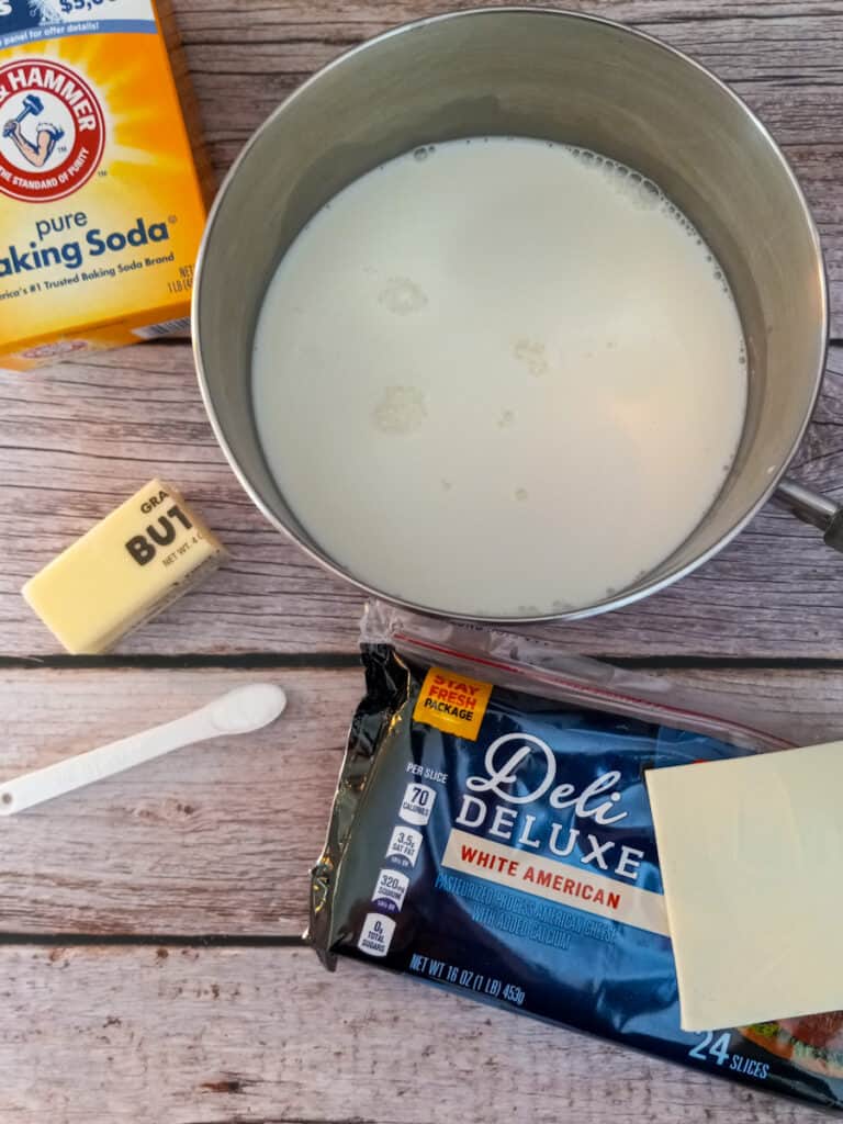 milk in pot, cheese slices, butter, salt, and baking soda