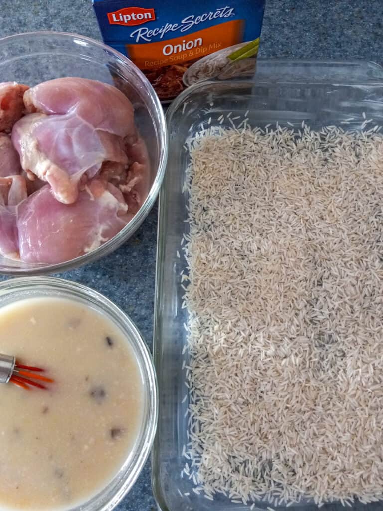 pan with rice, bowl of chicken, and bowl of mushroom soup mixture