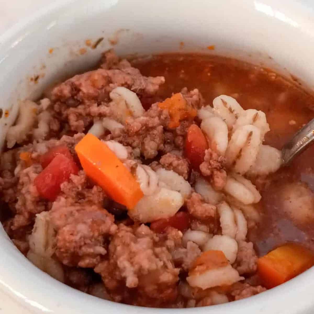 close-up of a crock with beef barley soup.