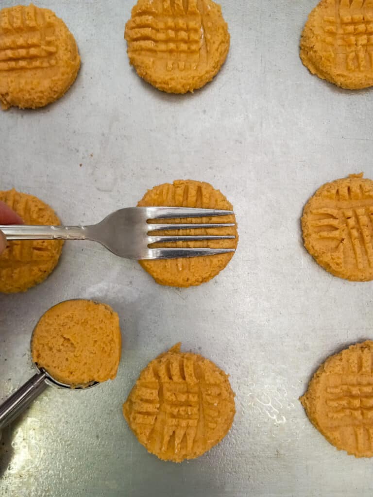 peanut butter cookies dough on a tray with crisscross patterns