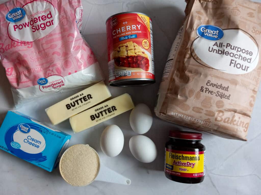 ingredients: flour, butter, eggs, yeast, sugar, powdered sugar, cream cheese, and cherry pie filling