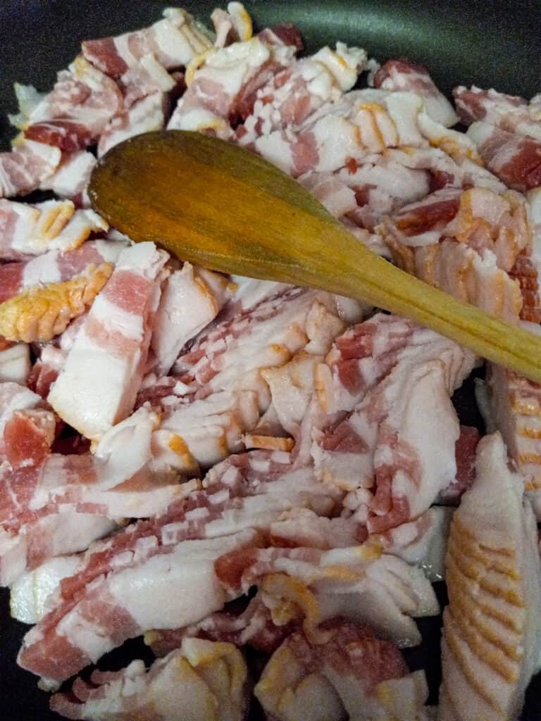 cut bacon pieces in a skillet