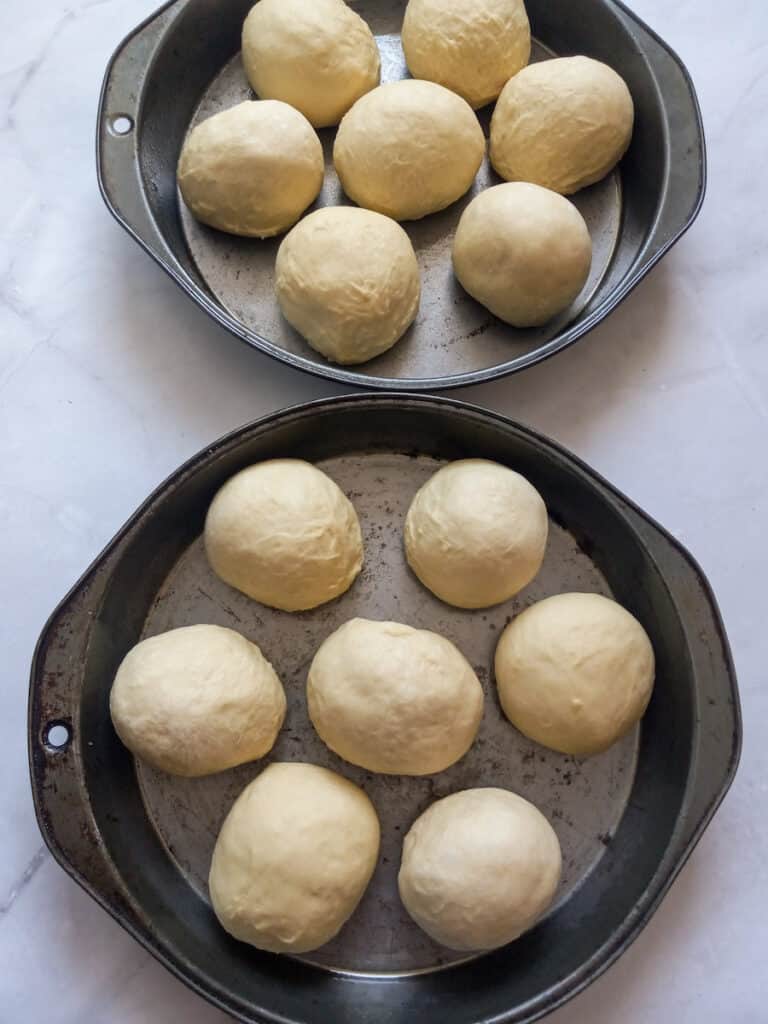 dough balls in round pans