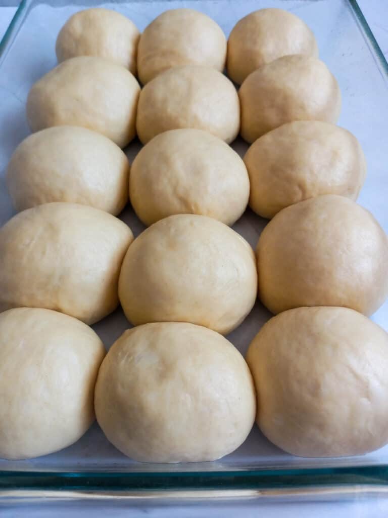 risen rolls in 9x13 pan ready to bake