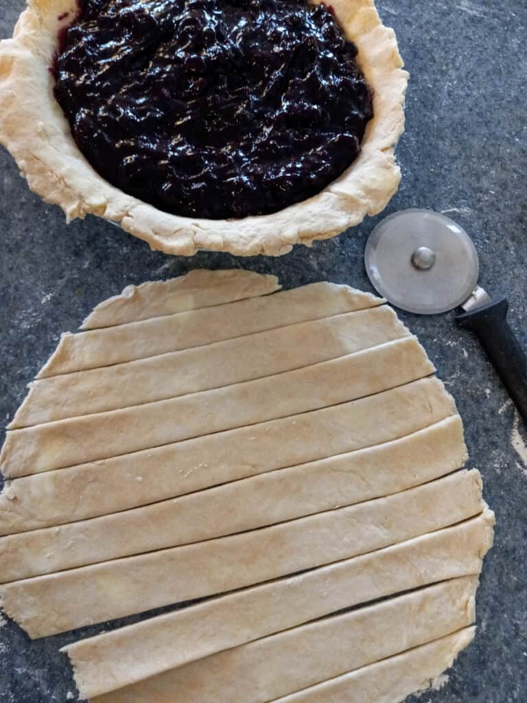 cut strips of dough to put on top of the blueberry pie