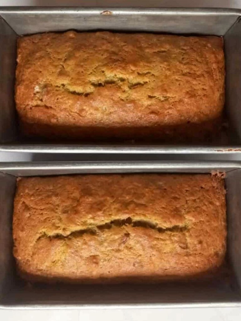 two loaves of baked banana bread in the pans.