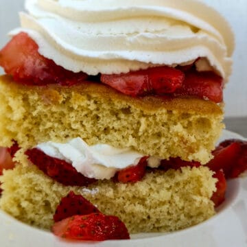 slice of shortcake piled with berries and whipped cream
