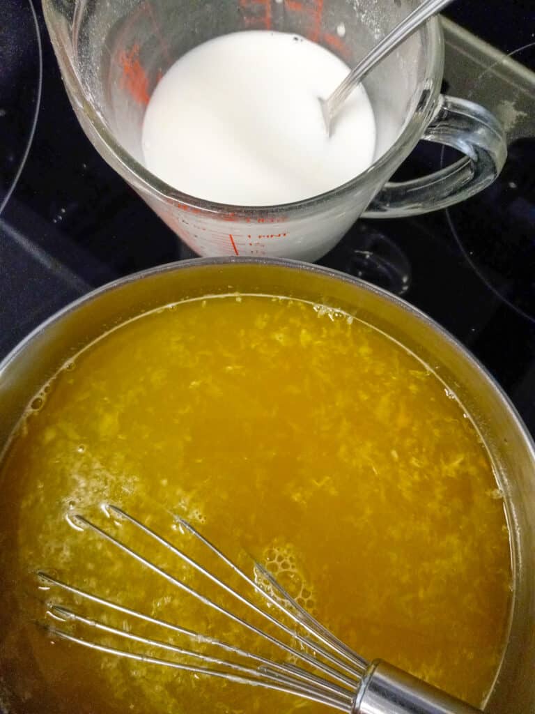 cooking sauce for fruit salad in a saucepan and clear jel slurry in a small pitcher