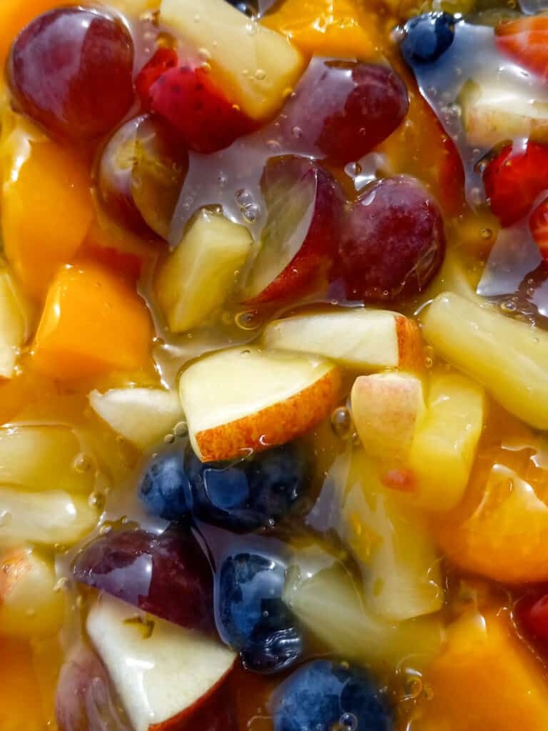 close up photo of fruit salad with sauce