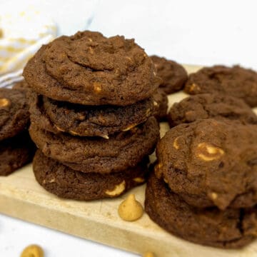 chocolate peanut butter cookies stacked on a board