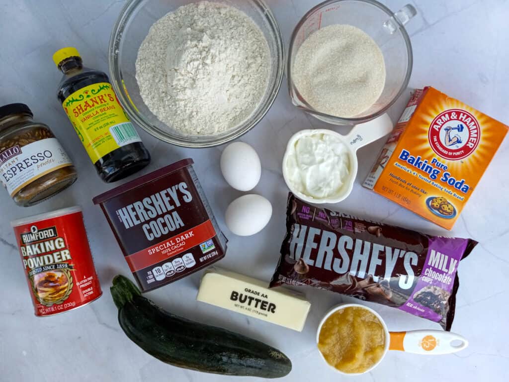 Ingredients: zucchini, applesauce, butter, sugar, flour, cocoa powder, baking soda, baking powder, espresso powder, eggs, sour cream, vanilla, and chocolate chips