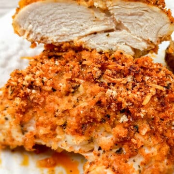 chicken breasts coated in bread crumbs and parmesan cheese