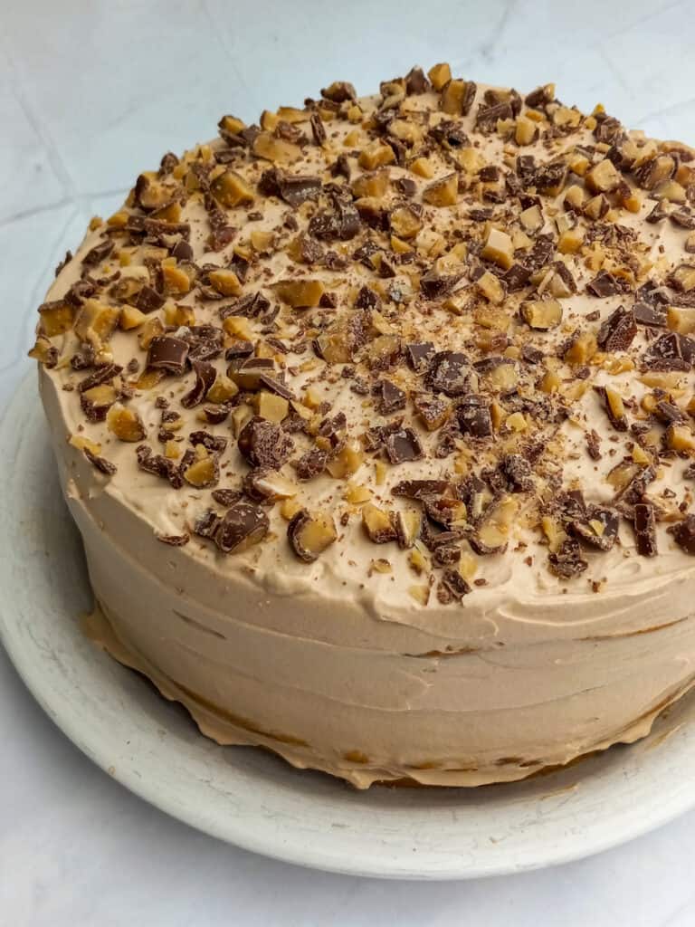Tiramisu Toffee Torte layered cake with mascarpone and chocolate frosting, topped with Heath candy crumbles.