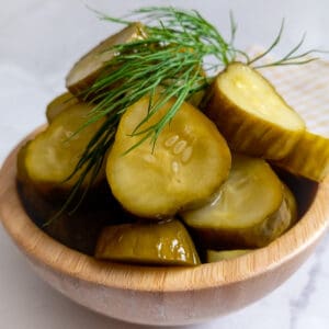 wooden bowl full of Amish refrigerator dill pickles