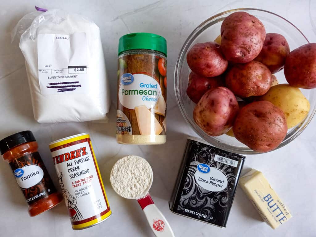 Ingredients: potatoes, Parmesan cheese, flour, salt, pepper, paprika, butter, and Greek seasoning