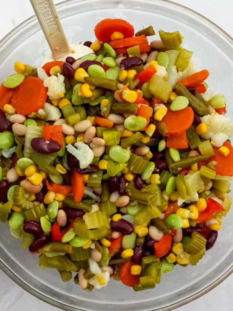 vegetables and beans mixed in a large bowl