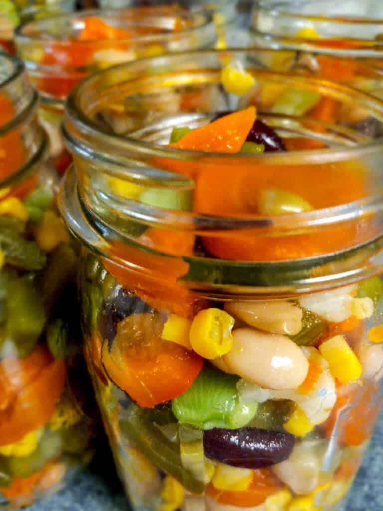side view of jars filled with colorful veggies