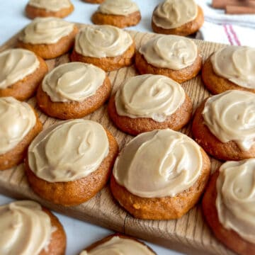 Amish pumpkin cookies with caramel frosting on a wooden board