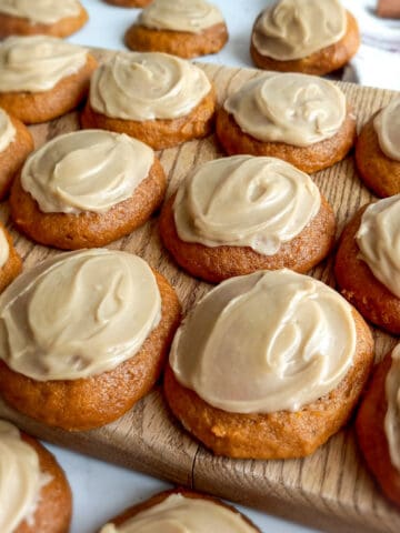 Amish pumpkin cookies with caramel frosting on a wooden board