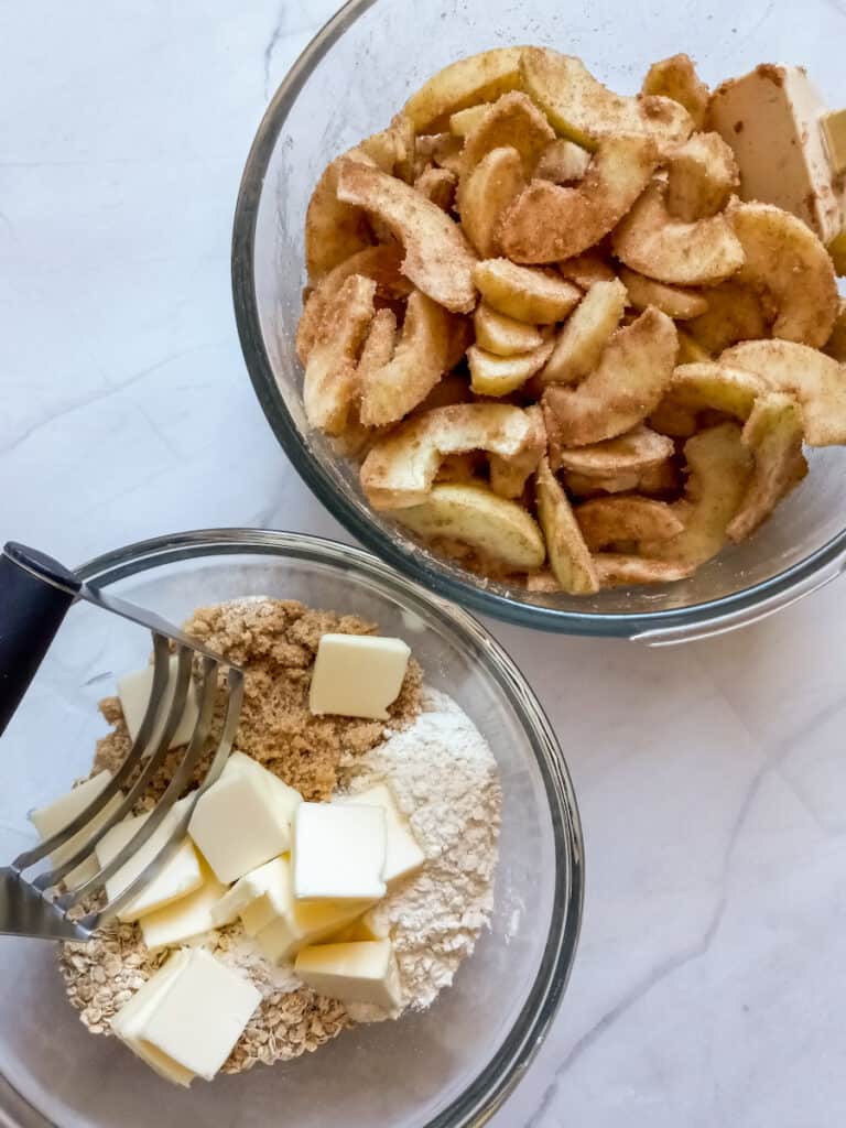 apple mixture in a one bowl, and oatmeal mixture with butter slices in another bowl