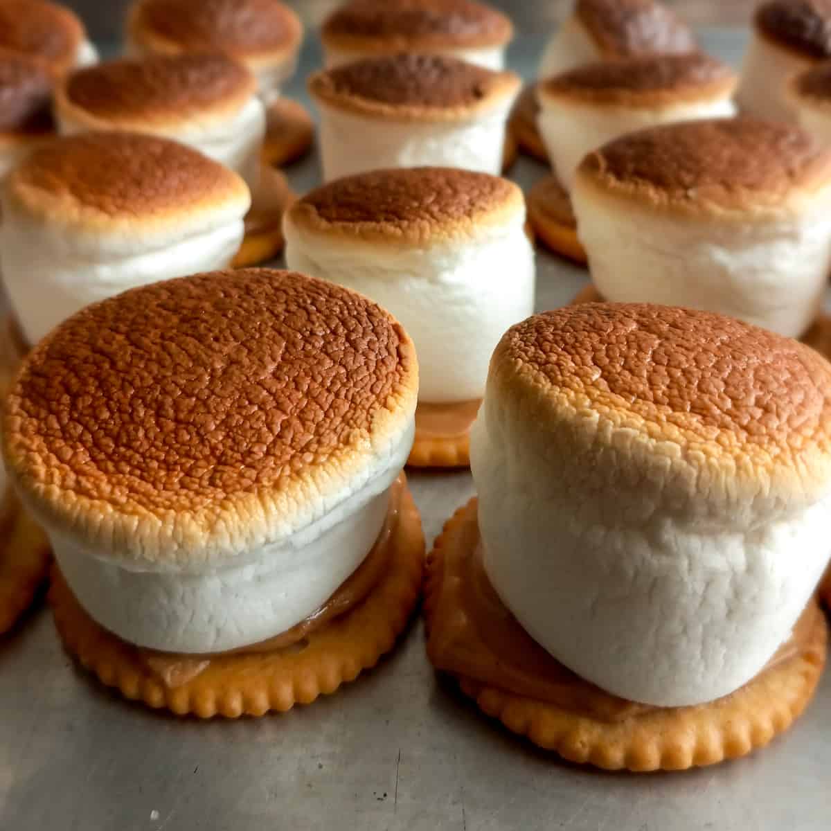 beautifully browned marshmallow hats on a tray.