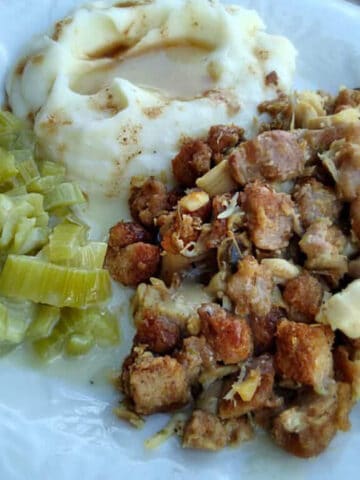 Amish wedding food on a plate: roasht, cooked celery, and mashed potatoes with gravy.