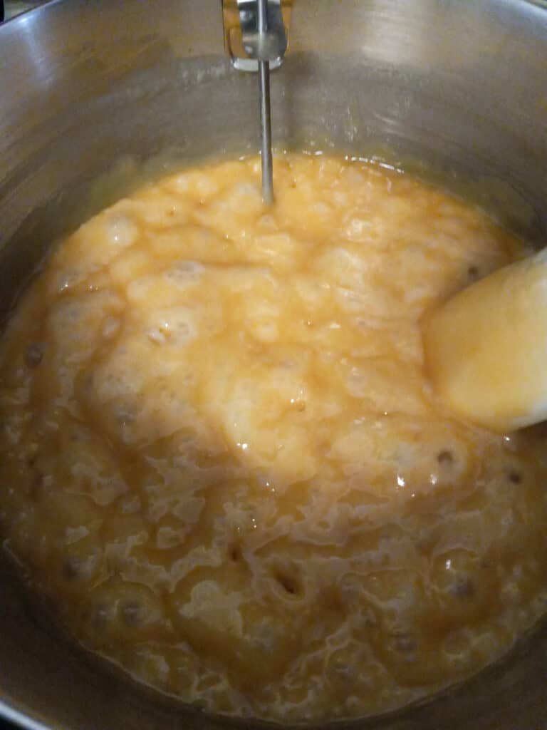 caramel cooking on the stovetop and it's getting darker in color.