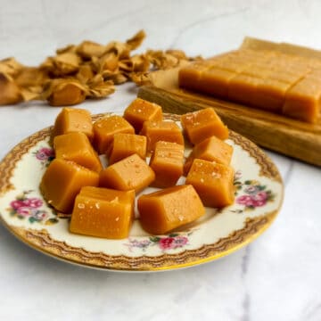 Amish caramels on a plate and rows of caramels on a board.