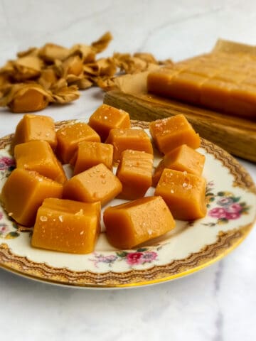 Amish caramels on a plate and rows of caramels on a board.